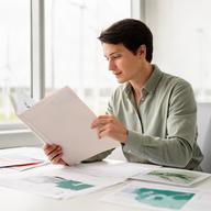Kátia Burgy, permitting and safety specialist, consulting county documents in a bright office